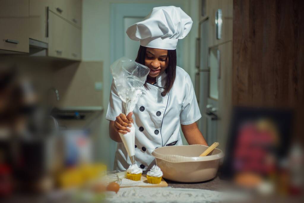A chef in whites preparing food in a kitchen